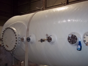 Horizontal fiberglass tank with custom manway and valves ready for hydrostatic testing